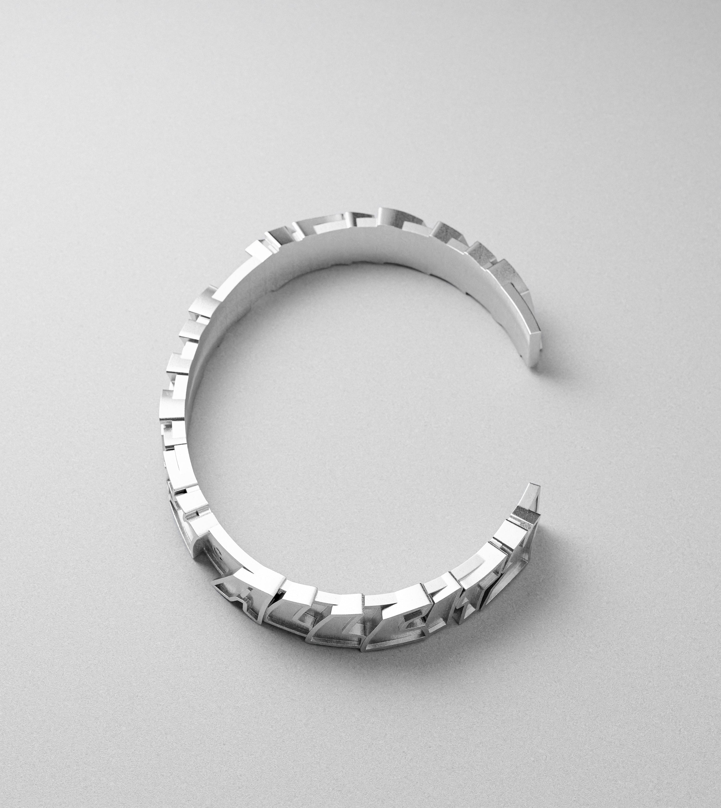 All City block letters silver bracelet by Cast Pieces, top view