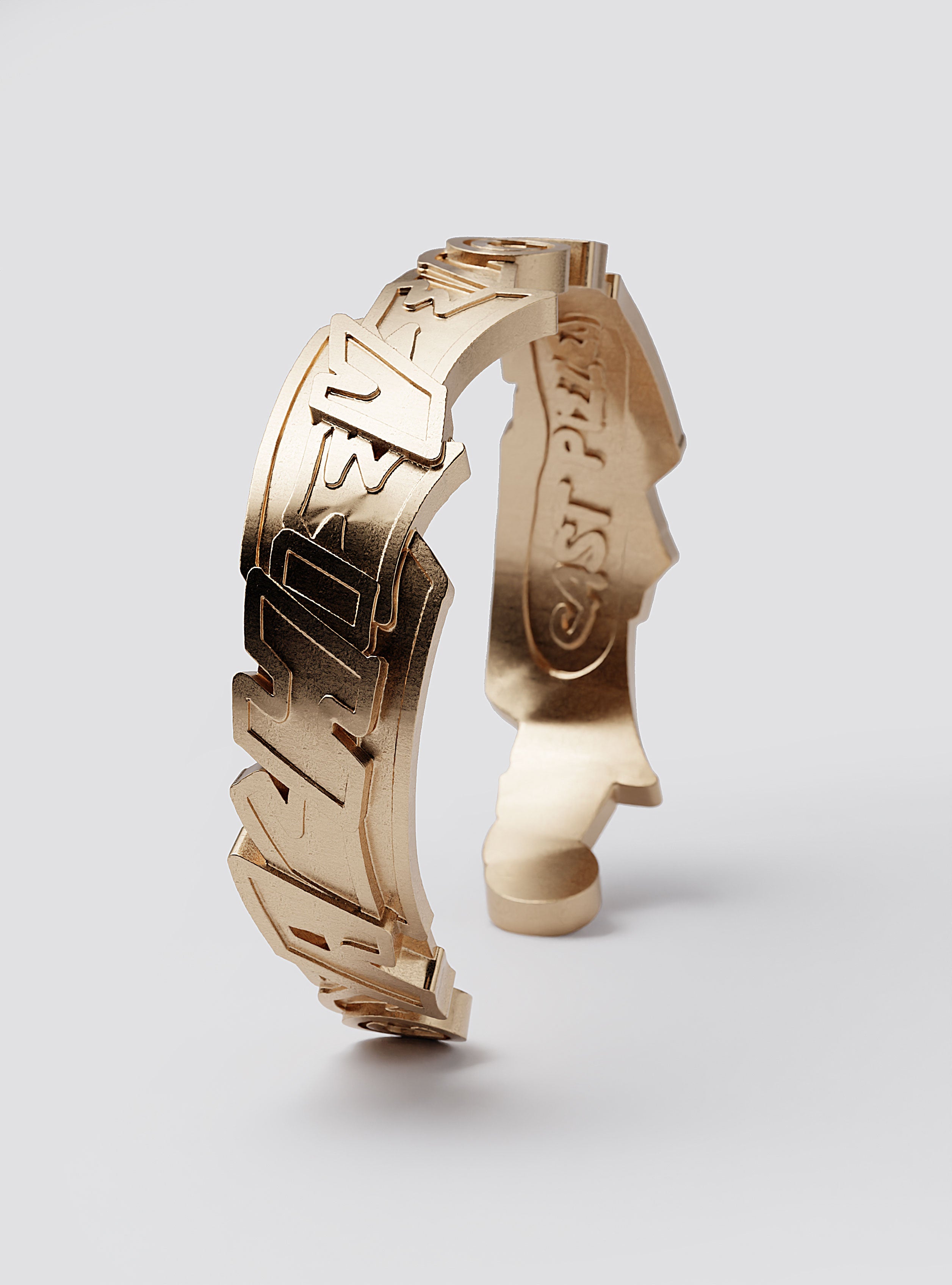 Cast Pieces gold Achieve wide cuff bracelet on display, designer edgy jewelry by Castpieces