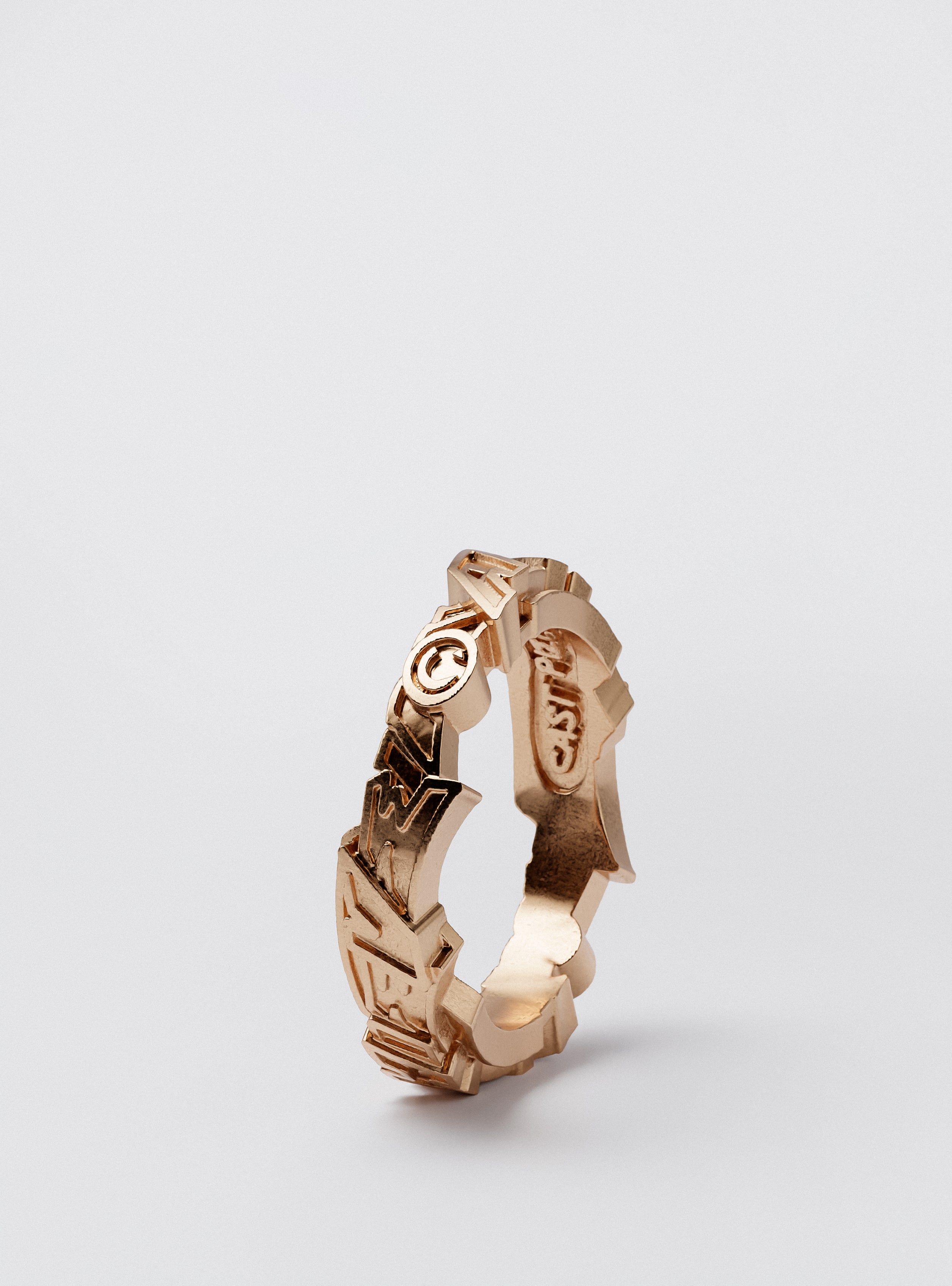 Side view of Cast Pieces gold Achieve narrow ring, street art statement jewelry by Castpieces