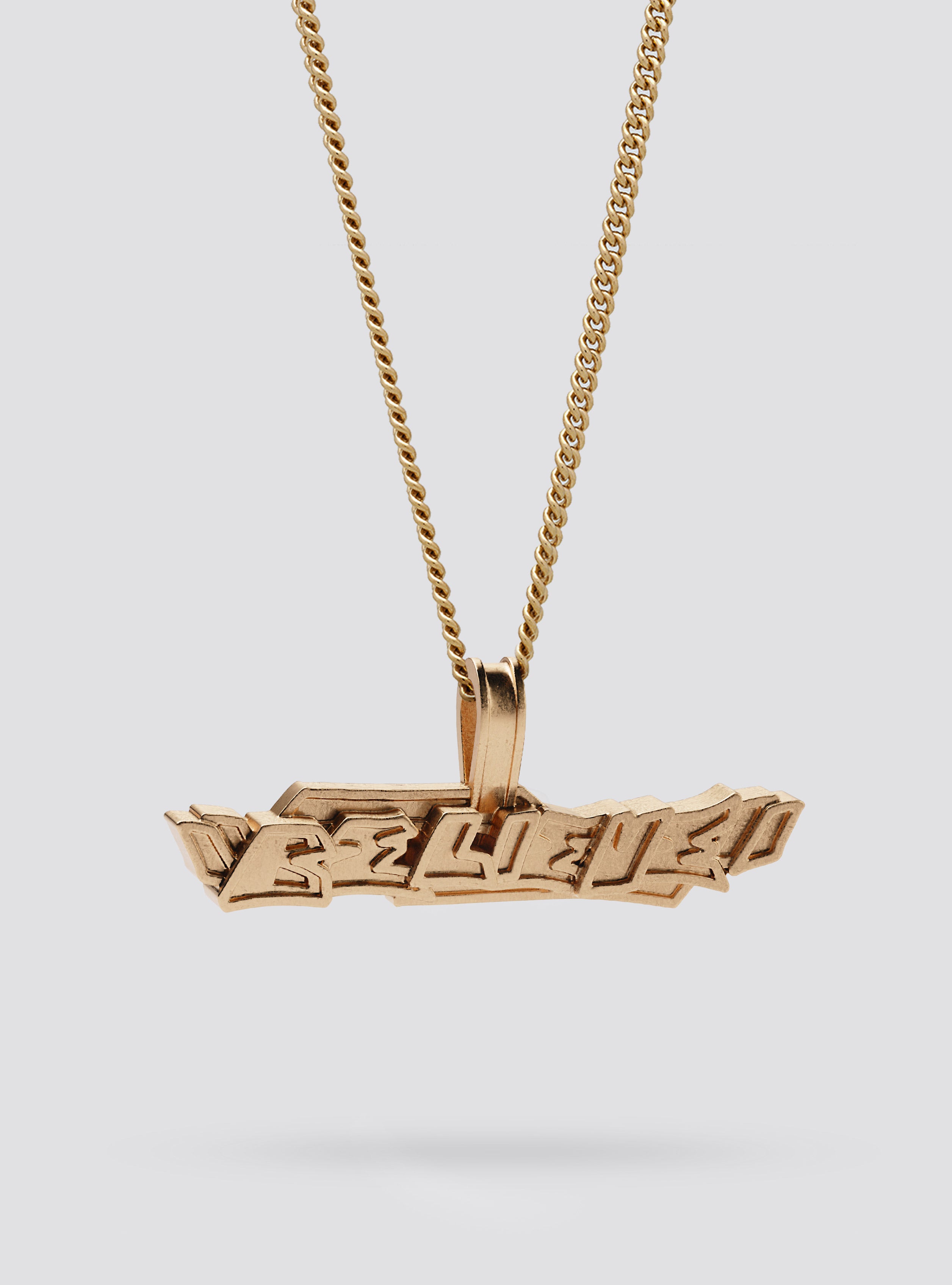 Side view of Cast Pieces gold Believe pendant, modern street style jewelry by Castpieces